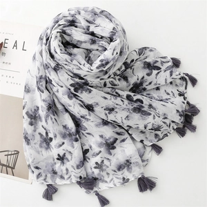 Detail of floral ink painting on lightweight white scarf with gray tassel edges