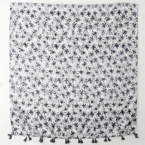 Floral print shawl with purple watercolor flowers and dark gray tassel edges