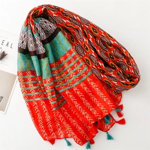 Detail of bohemian scarf with geometric patterns and colorful handmade tassels