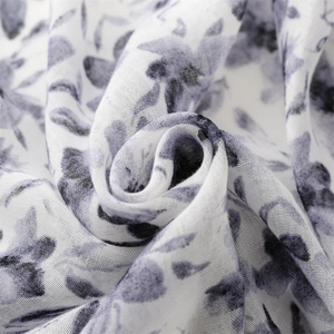 Close-up of floral print scarf fabric showing soft linen texture and weaving detail