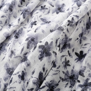 Close-up of lightweight chiffon fabric featuring vintage floral prints and soft texture