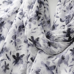 Macro detail of breathable ink wash floral fabric with elegant black and white patterns