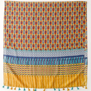 Detail of colorful geometric print scarf with ethnic patterns and fringe tassels