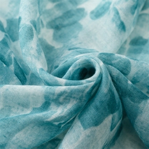 Close-up of blue and white tie-dye cotton linen scarf with breathable woven texture
