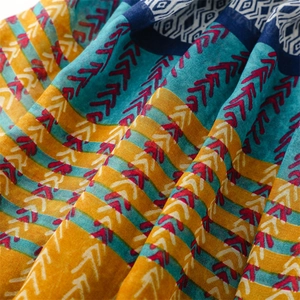 Macro detail of ethnic geometric patterns and textures on a cotton-linen scarf