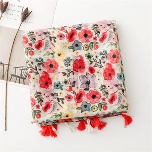 Detail of floral chiffon scarf with vibrant red flowers and white fringe tassels