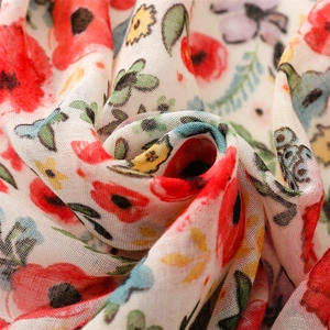 Detailed macro view of lightweight floral printed fabric with vibrant poppy and leaf pattern