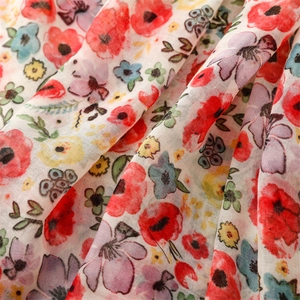Detailed macro shot of soft floral print chiffon fabric with colorful vibrant patterns