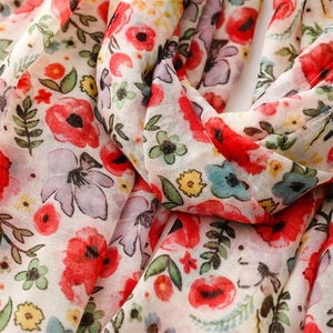 Detail of floral chiffon scarf showing soft texture and colorful garden pattern