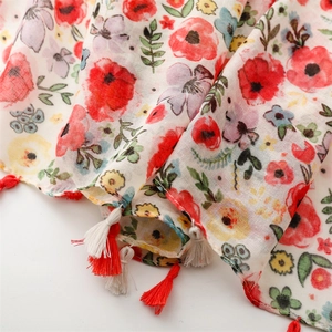 Detail shot of lightweight floral scarf with red poppy print and two-tone fringe edges