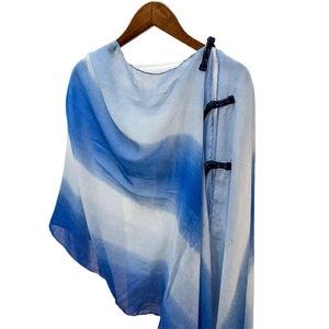 Blue and white gradient silk shawl with traditional Chinese button details on wooden hanger