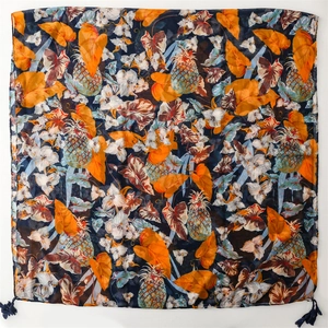 Detail of vibrant pineapple and tropical leaf print on navy scarf with blue tassels