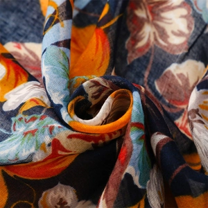 Macro shot of breathable floral cotton scarf showing weave texture and colorful fruit print