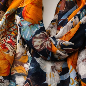 Detail of thin summer scarf showing colorful pineapple leaf print and woven texture