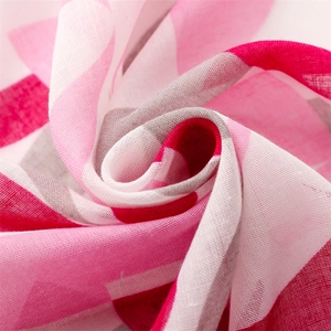 Close-up of geometric printed scarf fabric with breathable mesh texture and pink tones