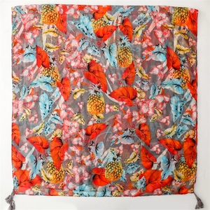 Detail of thin summer scarf with tropical pineapple floral print and grey tassels