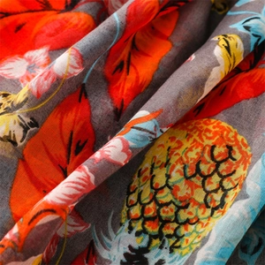 Macro shot of tropical fabric showing pineapple and leaf print with linen texture