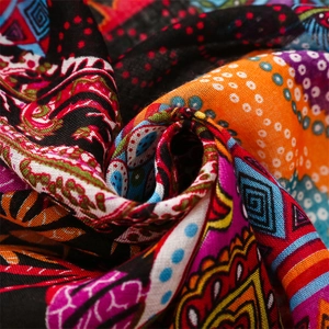 Macro shot of colorful Bohemian floral print fabric with tassels and soft linen texture