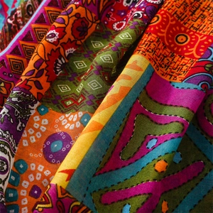 Close-up of bohemian red linen scarf texture with ethnic geometric patterns and tassels