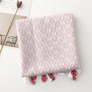 Detailed texture of pink strawberry leaf scarf with soft cotton-linen feel and tassels