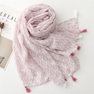 Pink scarf with strawberry leaf print and blue dots featuring decorative tassels