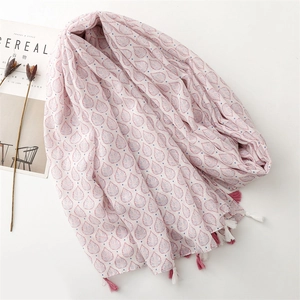 Detailed view of pink leaf patterns and bicolor tassels on a lightweight summer scarf