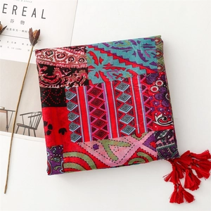Detail of red Bohemian shawl with fringe trim and vintage ethnic print patterns