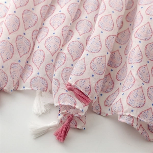 Close-up of lightweight strawberry leaf print scarf with pink and white tassel fringe