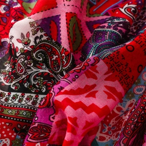 Detail of red Bohemian paisley pattern fabric with ethnic floral prints and soft texture