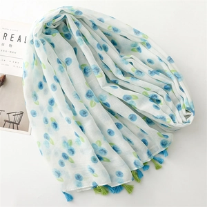 Detail of soft summer scarf with blue berry prints and colorful tassel edges