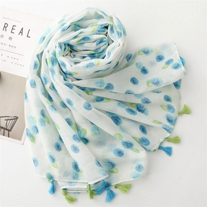 Blueberry print lightweight scarf with fringes on white background and magazine