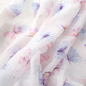 Detail of white cotton scarf with purple butterfly print and subtle silver glitter threads