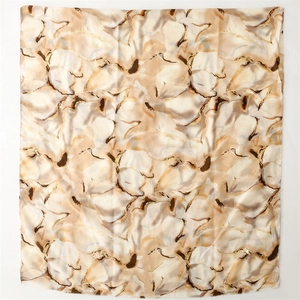 Close-up of abstract marble print scarf with metallic gold foil accents and soft texture