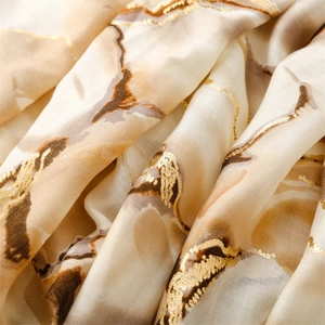Macro detail of marble pattern scarf with elegant gold foil accents and soft texture
