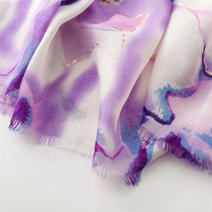 Detailed macro view of purple watercolor linen scarf with gold foil dots and frayed edges