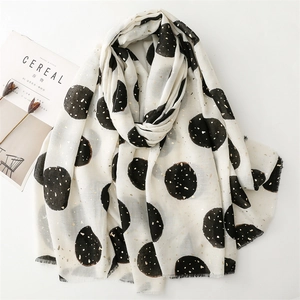Off-white cotton linen scarf with black polka dots and gold foil details and frayed edges