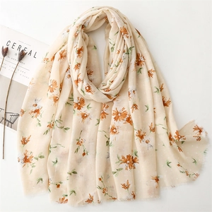 Beige cotton linen feel scarf with orange daisy floral print and frayed edges