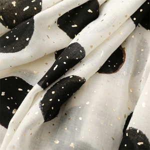 Detailed texture of white cotton linen scarf with black polka dots and gold foil foil stamping