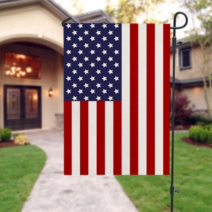 Independence Day garden flag with American flag design on black metal stand outdoors