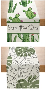 Detailed view of polyester table runners with cactus print and Enjoy This Day text