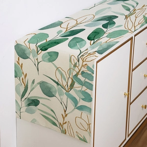 Modern polyester table runner with green eucalyptus print and gold leaf accents on white