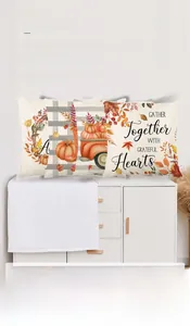 Close-up of harvest pumpkins and autumn wreath patterns on decorative pillow covers