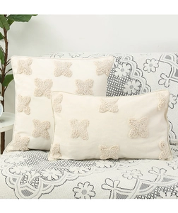 Close-up of tufted butterfly patterns on bohemian style off-white throw pillows