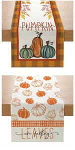 Detailed close-up of autumn harvest table runners with pumpkin prints and seasonal typography