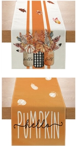 Close-up of autumn harvest table runner with pumpkin patterns and hello fall text