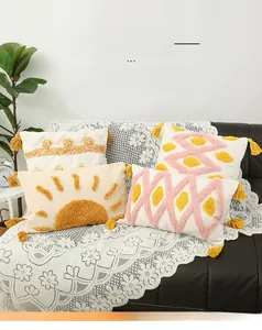 Detail of bohemian tufted cushions with geometric patterns and yellow tassel trim