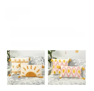 Detailed view of tufted geometric patterns and yellow tassels on boho cushion covers
