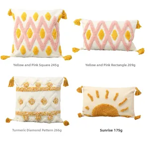 Detail view of tufted boho cushion covers with tassels and diverse geometric patterns