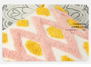 Close-up of tufted geometric pattern with pink waves and yellow dots on white cushion