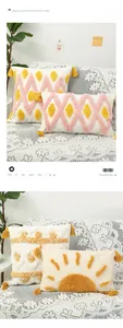 Detail of bohemian tufted cushion covers with geometric sun patterns and yellow tassels
